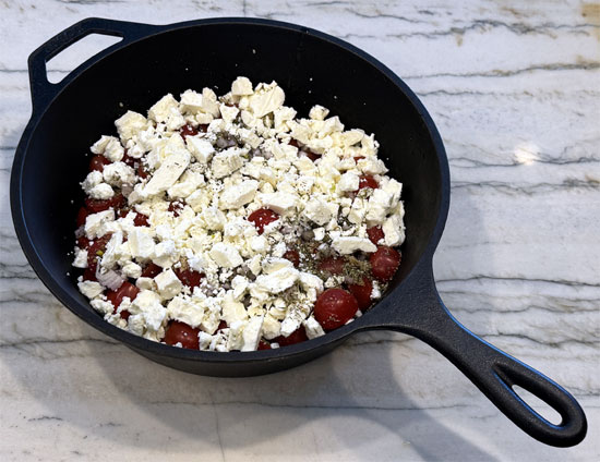 In an oven-safe baking dish, combine tomatoes, shallots, garlic, salt, feta cheese, olive oil, and Italian seasoning. Mix well.