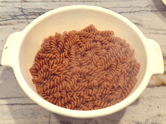 Drain pasta in a colander and rinse briefly with cold water (about 15 seconds) to stop the cooking process.