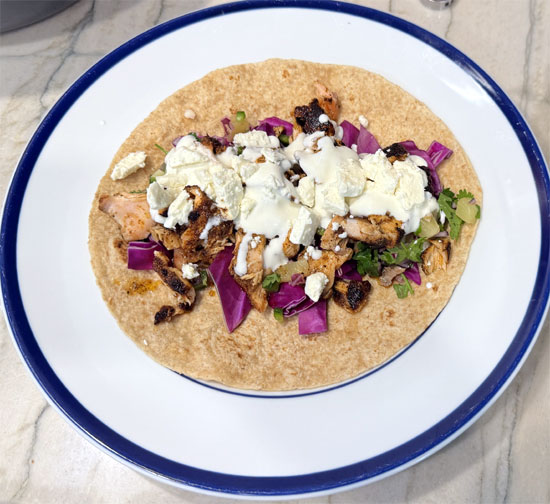 Spread a couple tablespoons of the sour cream on next and top with 1/3 of the crumbled feta cheese. Roll it up and enjoy.