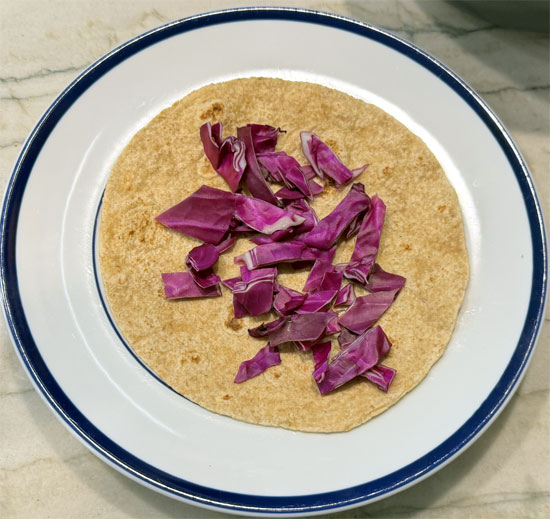 Spread 1/3 of the red cabbage on the tortilla