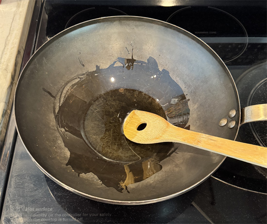 Heat a wok (or large skillet) over high heat. Then add the oil mixture to the hot wok.