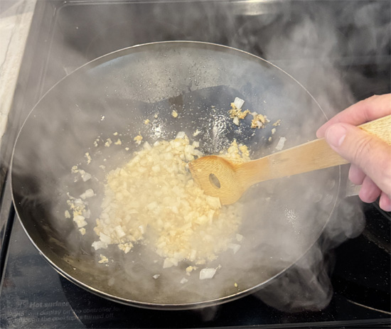 Immediately add the garlic, onion, and ginger. Stir constantly for 30 seconds.