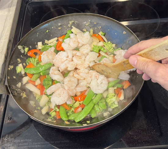 Add the shrimp. Stir constantly for 2–3 minutes, until the shrimp turn opaque (white) and are cooked through.