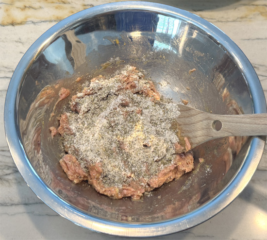 Stir in the seasoning ingredients: Put 1/3 of the seasoning in at a time, mix it into the turkey, then add more until it's thoroughly combined. 