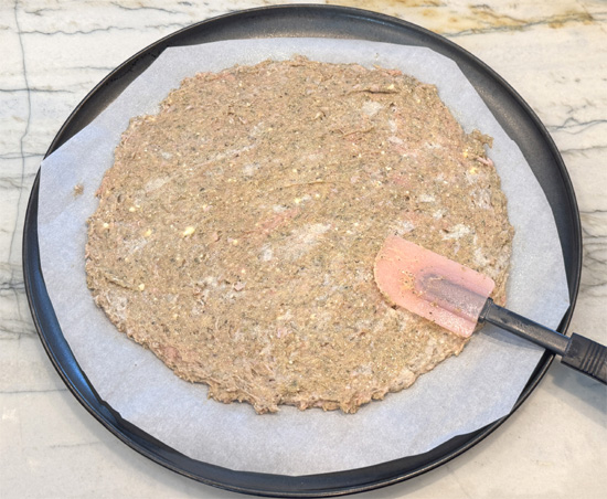 Shape the crust: Transfer mixture to prepared baking sheet with parchment paper. Using a silicone spatula or your hands, spread into a thin, even layer about 1/4 inch thick, forming a rectangle or circle shape. If you made a circle, the crust should be at least 12 inches across. 