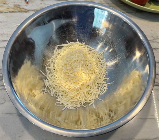 Combine cheeses: Mix together the fat free and regular shredded mozzarella. 