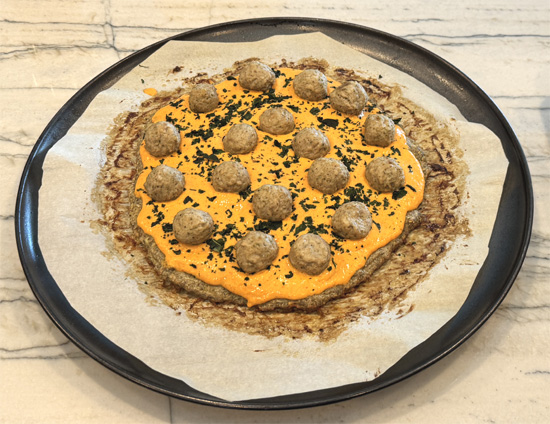 Add meatballs: Once the meatballs are baked, put them on top of the pizza. 12 around the edge and 6 inside so when you cut the pizza, each slice gets 3 mini meatballs.