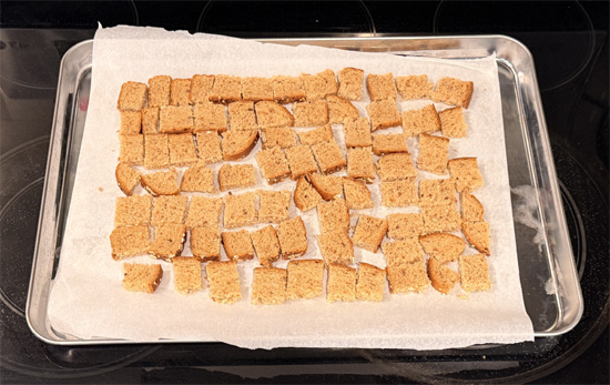 Cut the bread into small 1 inch squares. Spread the bread squares on the prepared baking sheet. Spray with olive oil and sprinkle with 1 Tbsp Everything Bagel seasoning. Bake 8 minutes, flip, spray again, and bake another 8 minutes until crunchy. Set croutons aside.