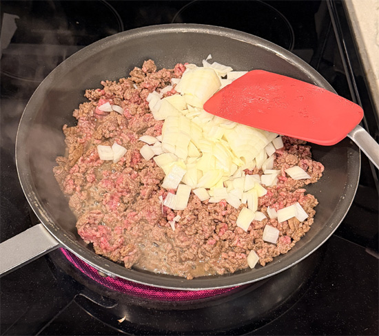 Heat a large pan over medium-high heat and spray with olive oil. Add the beef, breaking it into small pieces, and cook 2 minutes. Add the onion and Worcestershire sauce. Cook until beef is browned and onions are soft, about 5 minutes. Set aside to cool.