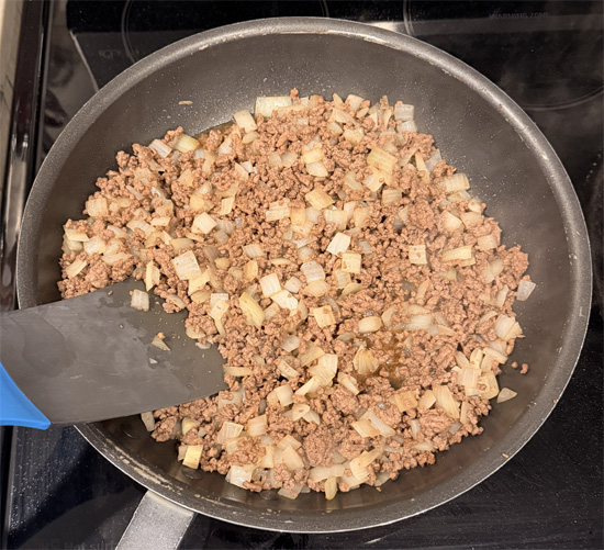 Heat a large pan over medium-high heat and spray with olive oil. Add the beef, breaking it into small pieces, and cook 2 minutes. Add the onion and Worcestershire sauce. Cook until beef is browned and onions are soft, about 5 minutes. Set aside to cool.