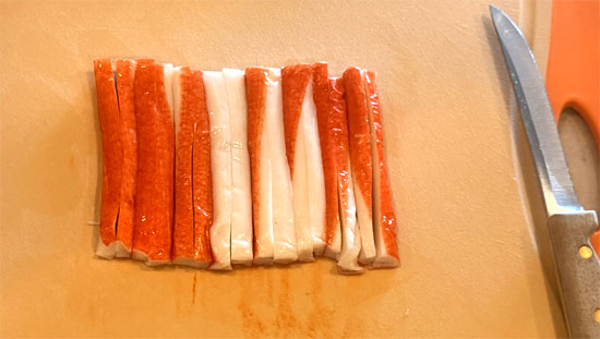 Chop imitation crab and add to the bowl along with the seaweed wraps, cut into small pieces. Toss to combine.