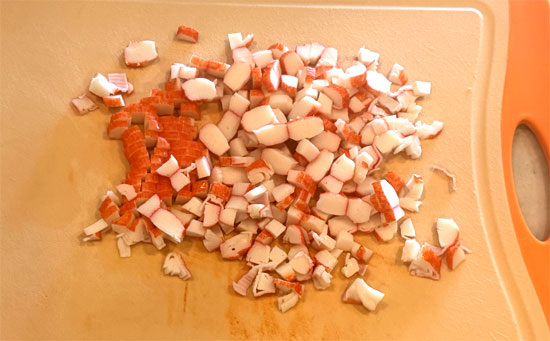 Chop imitation crab and add to the bowl along with the seaweed wraps, cut into small pieces. Toss to combine.