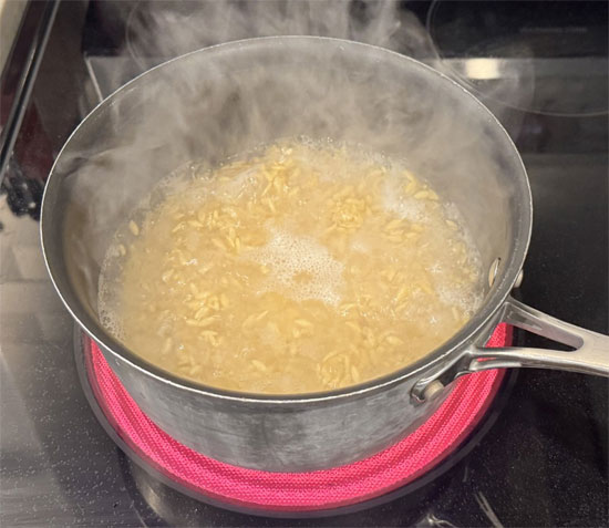Add orzo to the boiling water and cook for 8-10 minutes, reducing heat to medium-low and stirring occasionally until tender.