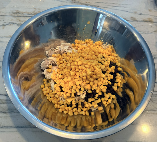Place the chicken, black beans, corn, red onion, bell peppers and cilantro in a large mixing bowl.
