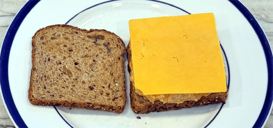 Top with the buffalo chicken mixture and cheddar cheese. Add the second slice of toast.