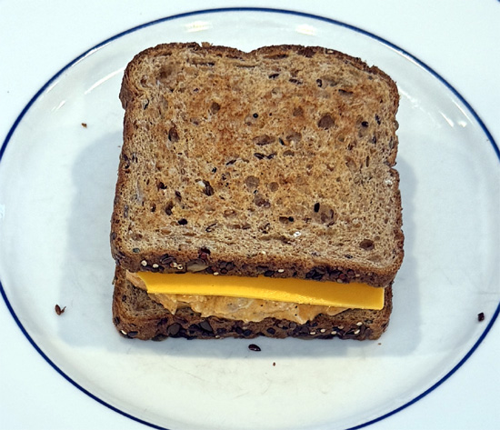 Top with the buffalo chicken mixture and cheddar cheese. Add the second slice of toast.