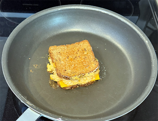 Add remaining butter to the pan, flip sandwich, and cook another 3-4 minutes until the second side is golden brown.