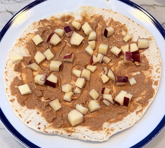 Scatter the apple and cereal over peanut butter.