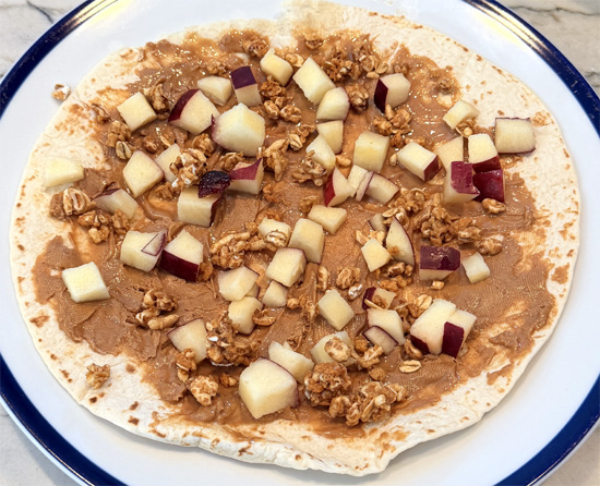 Scatter the apple and cereal over peanut butter.