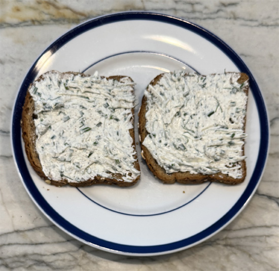 Spread the mixture evenly on two slices of bread. 