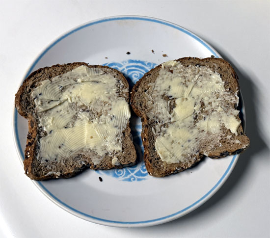 Butter one side of each slice of bread with the garlic butter, dividing it evenly.