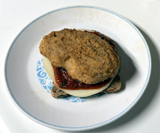 Assemble the sandwich: one slice of bread butter side down, a slice of provolone, 2 tablespoons marinara, the chicken patty, 2 more tablespoons marinara, the second slice of provolone, and the last slice of bread butter side up.