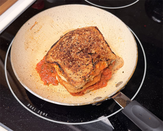 Heat a frying pan on medium. Once it's hot, put the sandwich in and cook until the bread is crisp and the cheese is melted, about 2-3 minutes per side.
