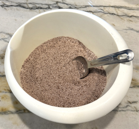 In a large mixing bowl, combine all dry ingredients and whisk thoroughly to ensure even distribution of the spices and powders.