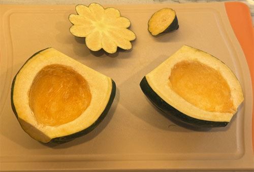 Wash the squash thoroughly and slice off the top and bottom. Then, place it on a flat end and cut it vertically in half. Remove the seeds with a spoon, rinse and pat dry. 