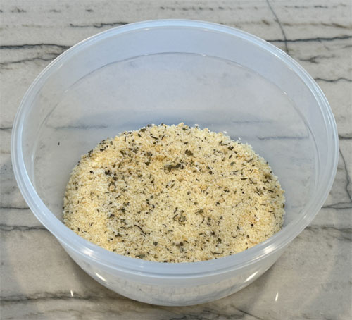 In a mixing bowl, stir together all the remaining ingredients except the olive oil. That's the parmesan cheese, garlic powder, salt, basil, thyme and oregano. 