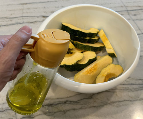 Lightly coat the squash with olive oil. I like using a mister with olive oil in it. Then, coat both sides with the squash in the cheese and herb mixture. 