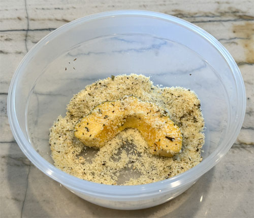 Lightly coat the squash with olive oil. I like using a mister with olive oil in it. Then, coat both sides with the squash in the cheese and herb mixture. 