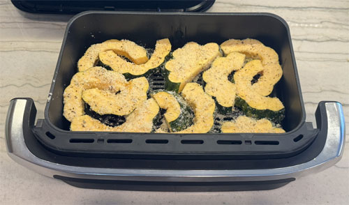 Place the coated squash in the fryer bin, in a single layer. Air fry at 400 degrees Fahrenheit for 13 to 15 minutes. Flip and air fry at 400 degrees Fahrenheit for an additional 5 minutes, until lightly browned. 