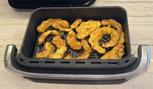 Place the coated squash in the fryer bin, in a single layer. Air fry at 400 degrees Fahrenheit for 13 to 15 minutes. Flip and air fry at 400 degrees Fahrenheit for an additional 5 minutes, until lightly browned. 