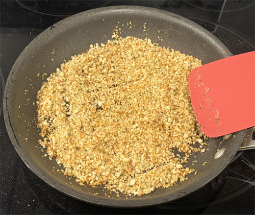 Stir in the panko breadcrumbs with the heat still on medium. Ensure the grease is fully absorbed, and stir frequently until the panko is lightly browned.