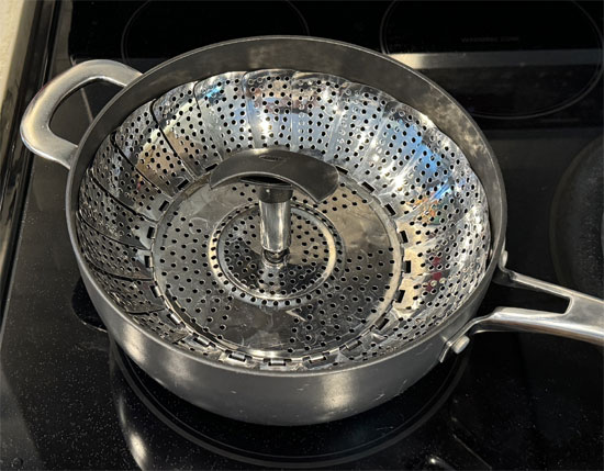 Once the water is boiling, place the steamer basket in the pot, add the green beans, and cover with a lid. Steam for about 15 minutes, or until the beans are tender.
