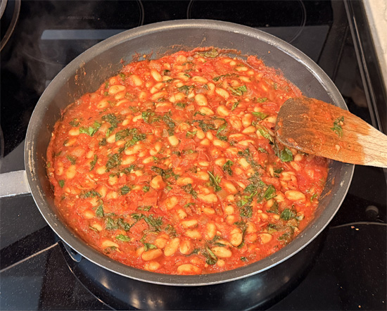 Turn off the heat under the frying pan. Mix together the two mozzarella cheeses. Then sprinkle that cheese over top the beans. 