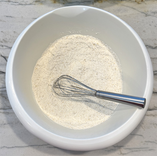 In a mixing bowl, combine the next five ingredients: flour, adobo, garlic, pepper and beer. This is the batter. Whisk it together and set aside. 