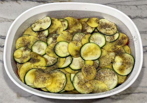 Zucchini-Potato Casserole with Salt, Pepper and Butter on Top