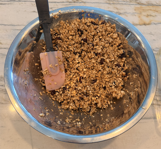 Pour the syrup over the oat mixture and stir until everything is thoroughly coated, then press it firmly and evenly into the prepared pan.