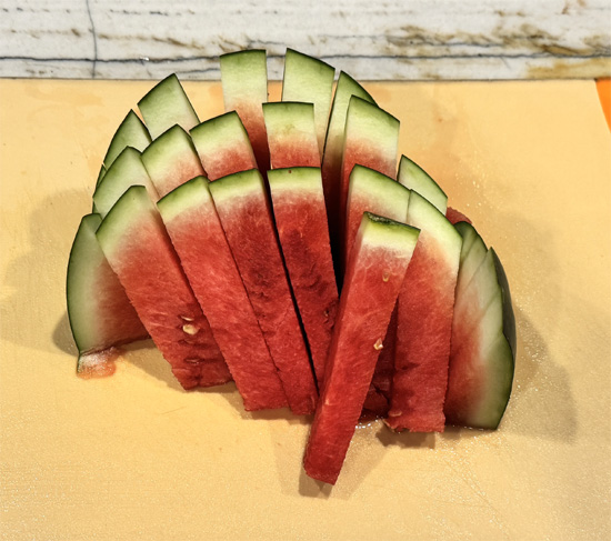 Now, rotate the watermelon 90° and slice again, making a criss-cross. You’ll end up with sturdy, easy-to-grab spears.