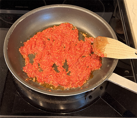Put the olive oil, garlic and tomato in the pan and mix together, cooking for about 3 minutes. 