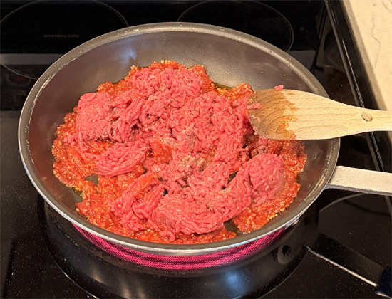 Add the ground beef to the pan, mix together and keep stirring until fully browned, about 5-7 minutes. 