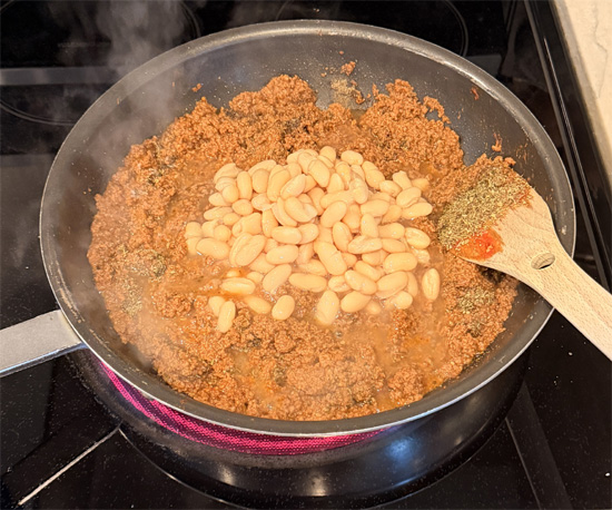 Stir in the salt, pepper, chili flakes, Italian seasoning, basil, cannellini beans, vodka sauce and lentils. Mix together. 