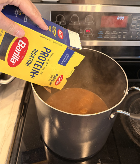 Add in the protein pasta. Reduce heat to low, cover and cook for 20 minutes, stirring every 5 minutes or so. 