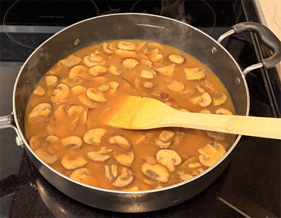 Slowly pour in the broth, mixing everything together. Then bring the broth to a boil. 
