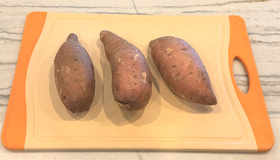 Heat a large pot or pan over medium heat. Add olive oil, sweet potatoes, and onion. Cook, stirring occasionally, until onions become tender, about 8 to 10 minutes. 