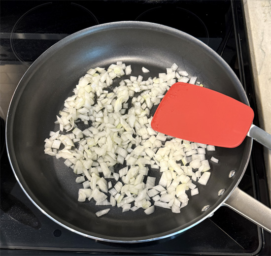 Heat a large nonstick frying pan over medium heat while the beans are warming up. Add the avocado oil and onions, then cook for 5-7 minutes until the onions start to turn translucent.