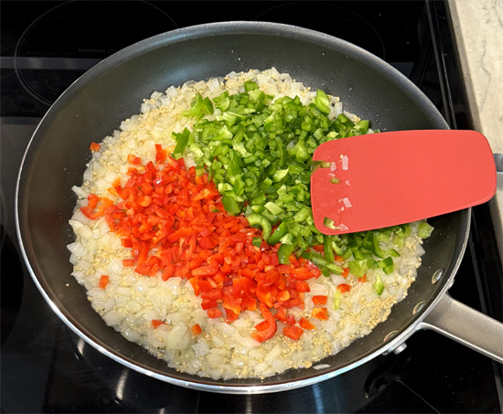 Stir in the bell peppers with the onions and continue cooking for another 2 minutes.