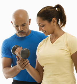Woman working out with personal trainer. 